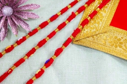 Show details for Raksha Potli With Golden Dhaga Picture of Raksha Potli With Golden Dhaga