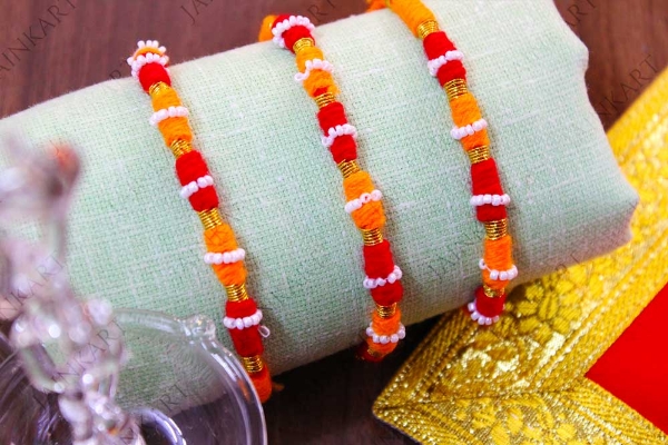 Picture of Orange Raksha Potli With Golden Dhaga