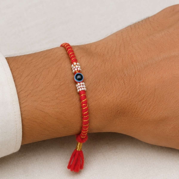 Picture of Red Raksha Potli With Nazar Symbol And White Moti